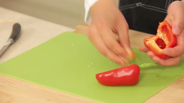 Cheff is Cutting Red Paprika on a Cutting Board - Кадры, видео
