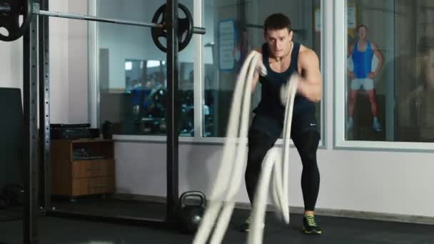 Man doing battling rope exercise at the gym - Materiaali, video