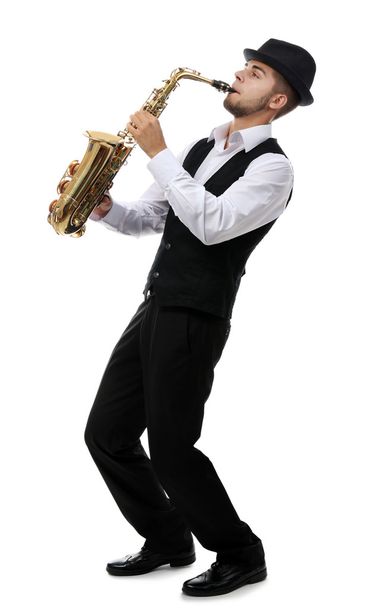 Happy saxophonist plays music on sax in elegant suit on white background - Photo, Image