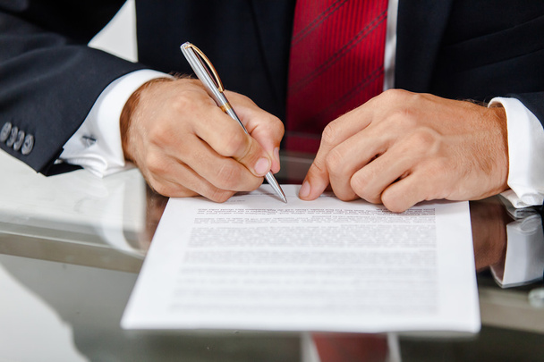 Businessman writing on a form - Photo, image