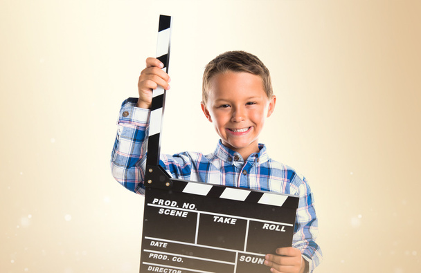 Kid holding a clapperboard - Zdjęcie, obraz