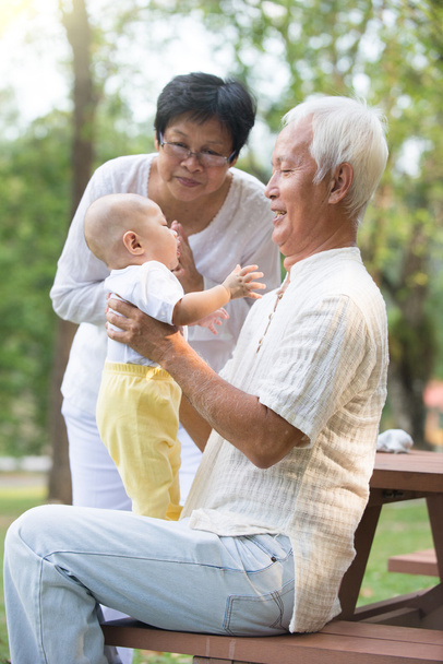 Бабушка и дедушка играют с ребенком
 - Фото, изображение