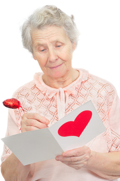 Senior woman hold post-card with heart shape on it cover - Valokuva, kuva