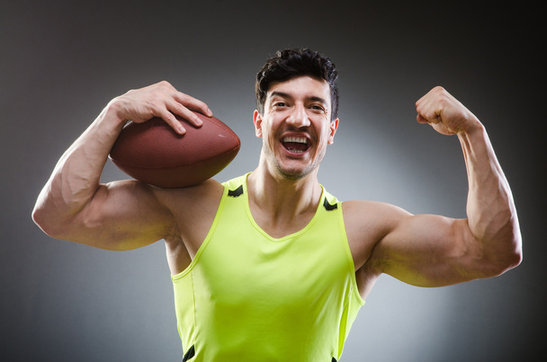 Muscular man with american football - Zdjęcie, obraz