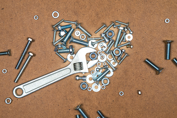 Bright heart with wrench from bolts and nuts - Foto, imagen