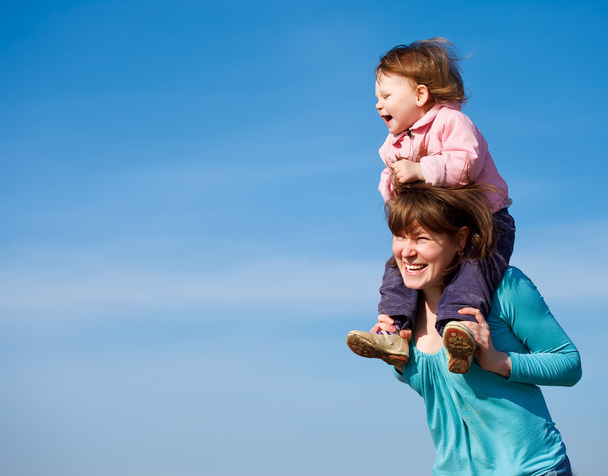 Portrait of cheerful mother and baby girl - Photo, Image