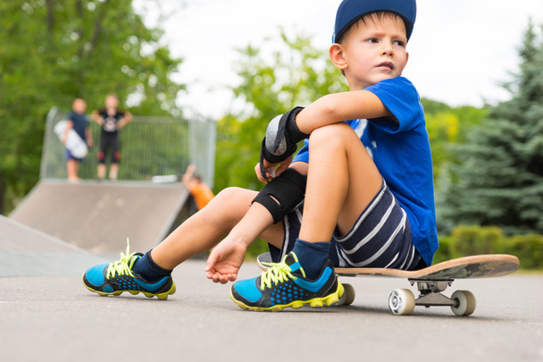 Boy on Skateboard Taking a Break in Skate Park - Фото, зображення