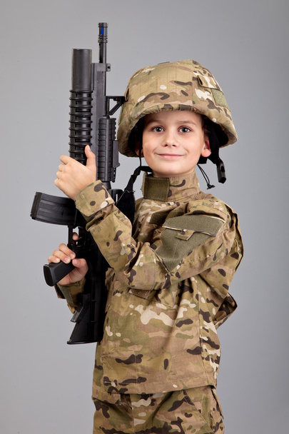 Young boy dressed like a soldier with rifle - Fotoğraf, Görsel
