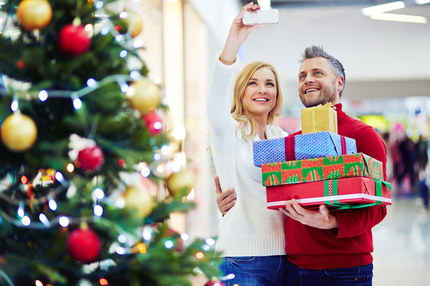 couple with presents making selfie in mall - Photo, Image