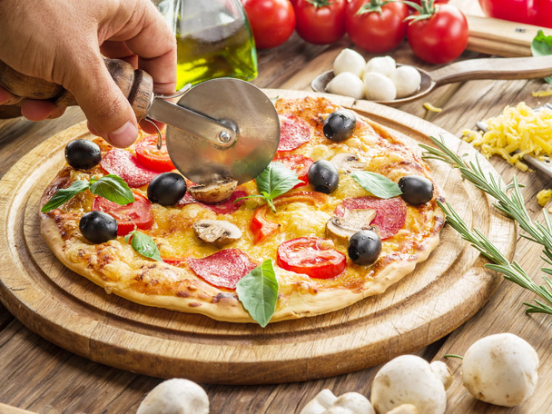 Pizza with mushrooms, salami and tomatoes. - 写真・画像