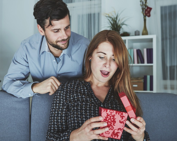 young couple is happy with gift for christmas - Zdjęcie, obraz