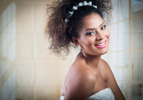 Portrait of young hispanic curly girl wearing wedding dress - Fotó, kép