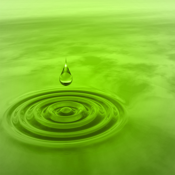 Concept or conceptual green liquid drop falling in water with ripples and waves background - Photo, Image