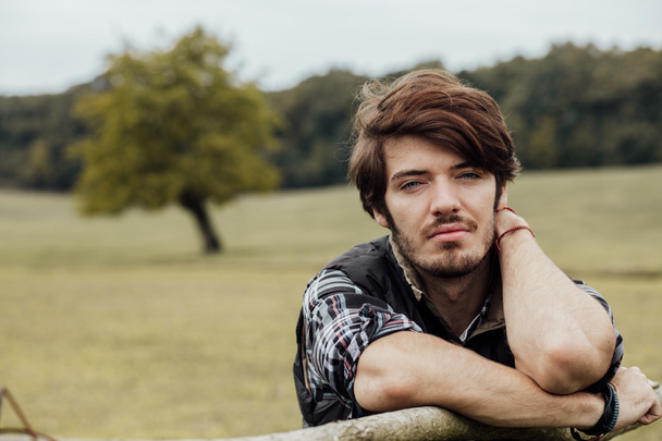 young man next to a wooden fence - Fotografie, Obrázek
