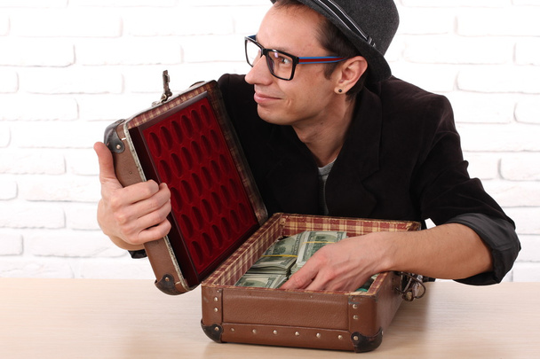 Emotional man in glasses holding bundles of money - Photo, Image