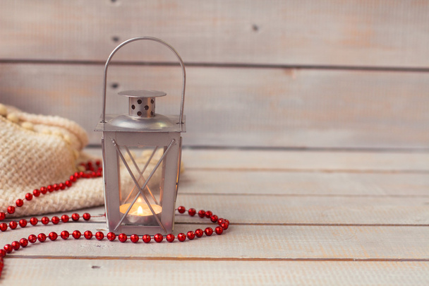 Christmas Lanterns and red beads on wood background. - Photo, Image