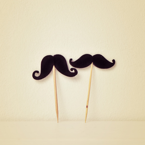 felt mustaches in sticks, retro effect - Foto, Imagen