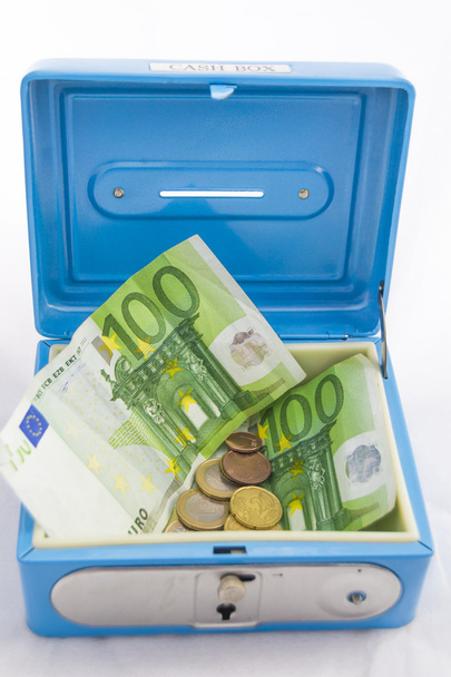Stacks of euro coins and banknotes in a cash box - Foto, Bild