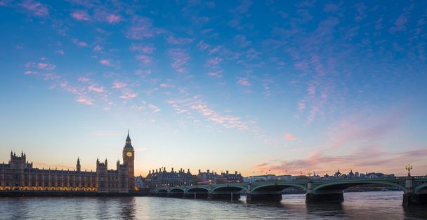 Big Ben and Westminster Bridge and Parliament with colorful clouds at dusk, London, UK - Photo, Image