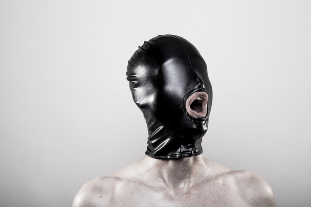 Man with black rubber mask hood blindfold - Fotoğraf, Görsel