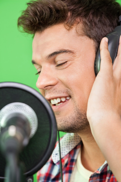 Smiling Singer Performing In Recording Studio - Foto, immagini