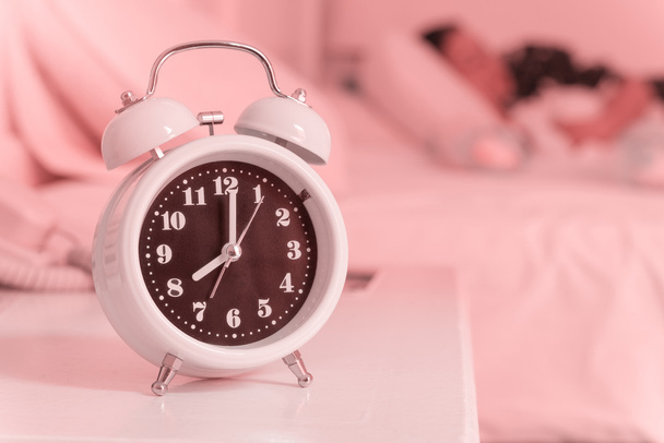 alarm clock on the bed in bedroom, retro style - Фото, зображення