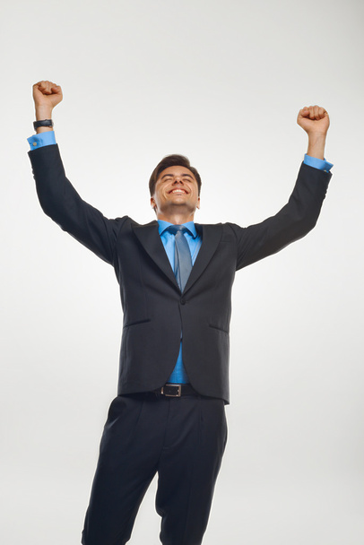 Business Man Celebrating Success against White Background - Foto, afbeelding