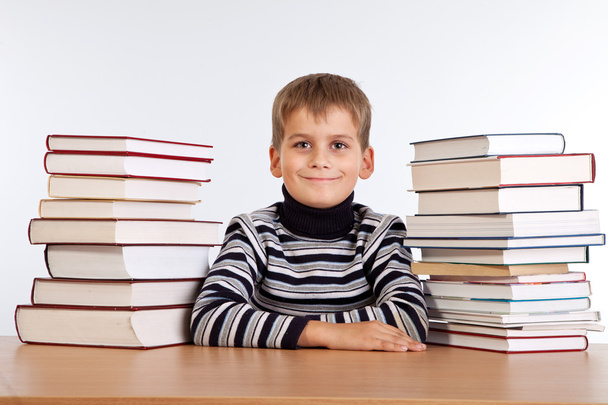 Schoolboy and a heap of books - Foto, imagen