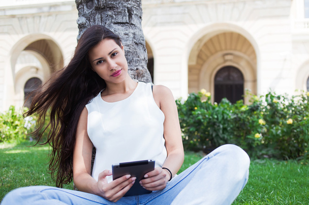 Woman using tablet computer outdoors - Photo, image