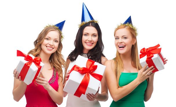 three smiling women in blue hats with gift boxes - Photo, Image