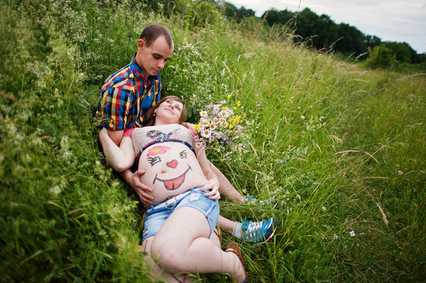 Happy young couple expecting baby, pregnant woman with painted b - Photo, Image