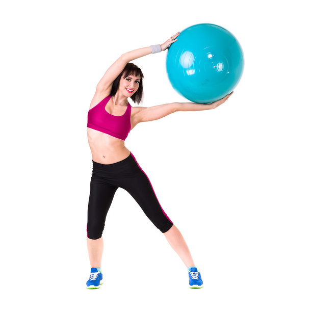 Young smiling woman makes exercise with fitball, full length portrait isolated over white - Valokuva, kuva