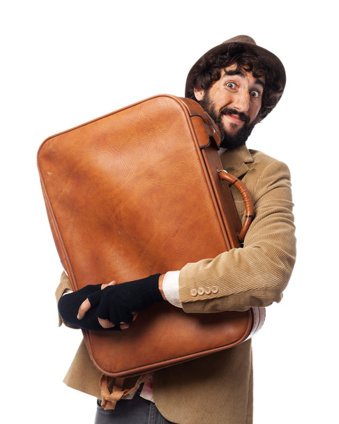 счастливый молодой человек с чемоданом
 - Фото, изображение