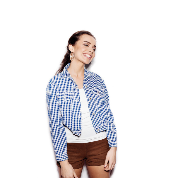 Happy smiling girl in a blue plaid shirt on white background - Foto, Bild