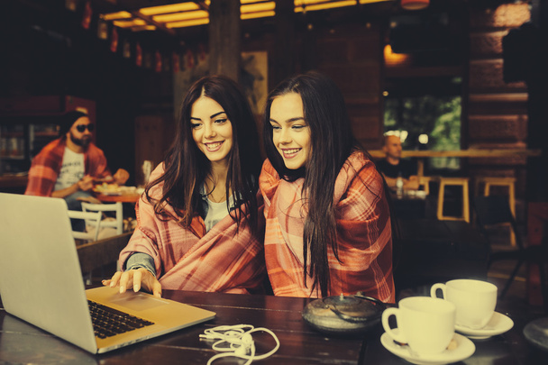 two girls watching something in laptop - Photo, Image
