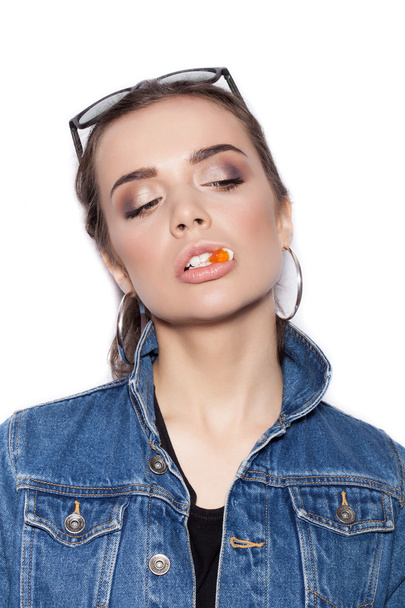 Joven sexy latina mordiendo caramelos de gelatina
 - Foto, Imagen