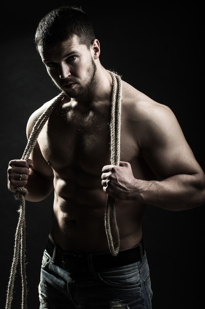 Muscular man with rope - Фото, изображение