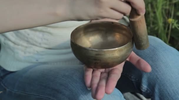Young beautiful lady relaxing with nepal singing bowl - Footage, Video