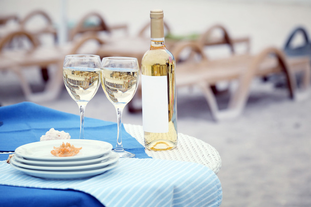 Served white table with Wine bottle and glass - Photo, image