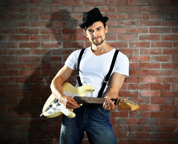 Young man playing guitar - Fotografie, Obrázek