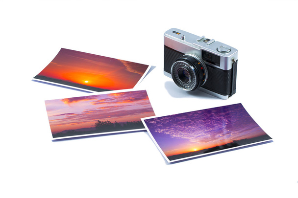 Old SLR camera with photo prints isolated on white background - Photo, Image