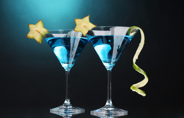 Blue cocktail in martini glasses on blue background - Photo, Image