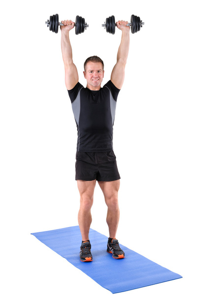 young man shows finishing position of shoulder press - Photo, Image