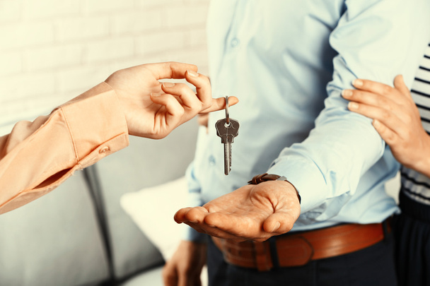 Real estate agent giving keys  - Foto, Bild
