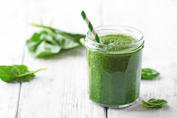 Glass of spinach juice on wooden background - Photo, image