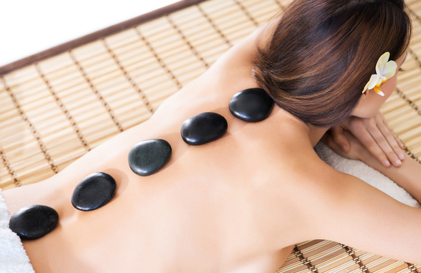 woman having hot stones on her back - Fotografie, Obrázek