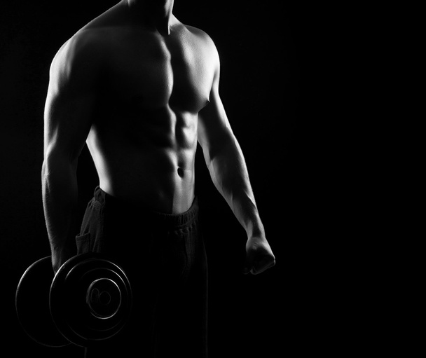 sporty bodybuilder man with  dumbbell - Foto, afbeelding
