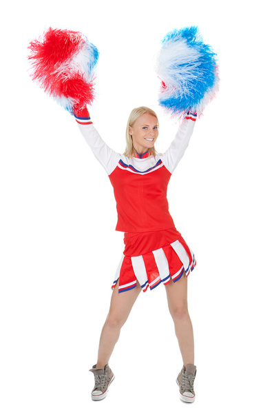 Smiling beautiful cheerleader with pompoms. - Fotó, kép