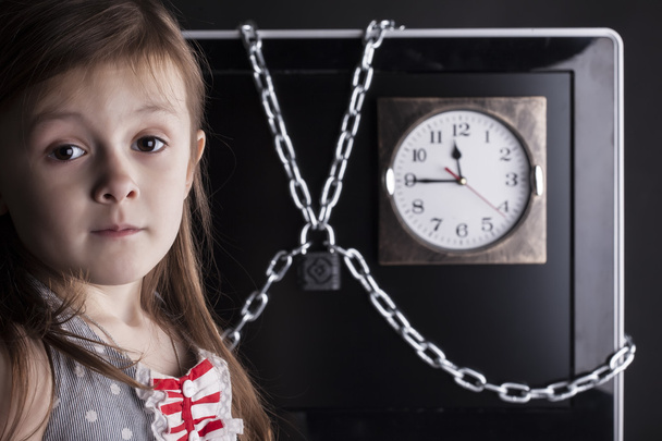 Child, girl, TV or comhuter closed with chain lock, clock - Foto, Imagem