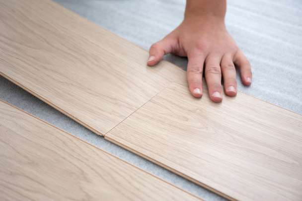 male hands intalling wood flooring - Photo, Image